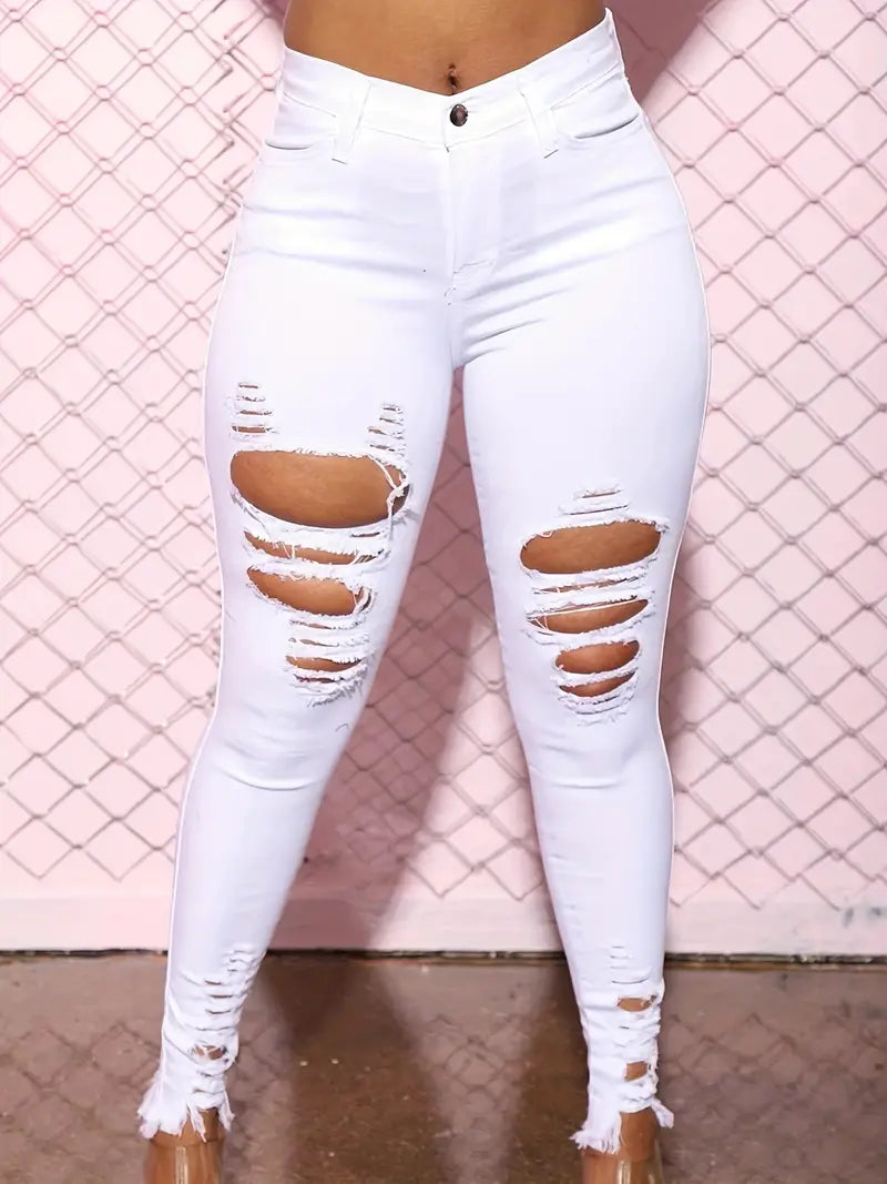Vaqueros ajustados de cintura alta con rotos y dobladillo sin rematar