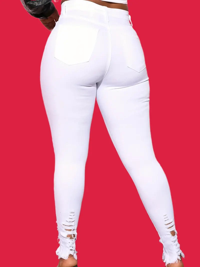 Vaqueros ajustados de cintura alta con rotos y dobladillo sin rematar